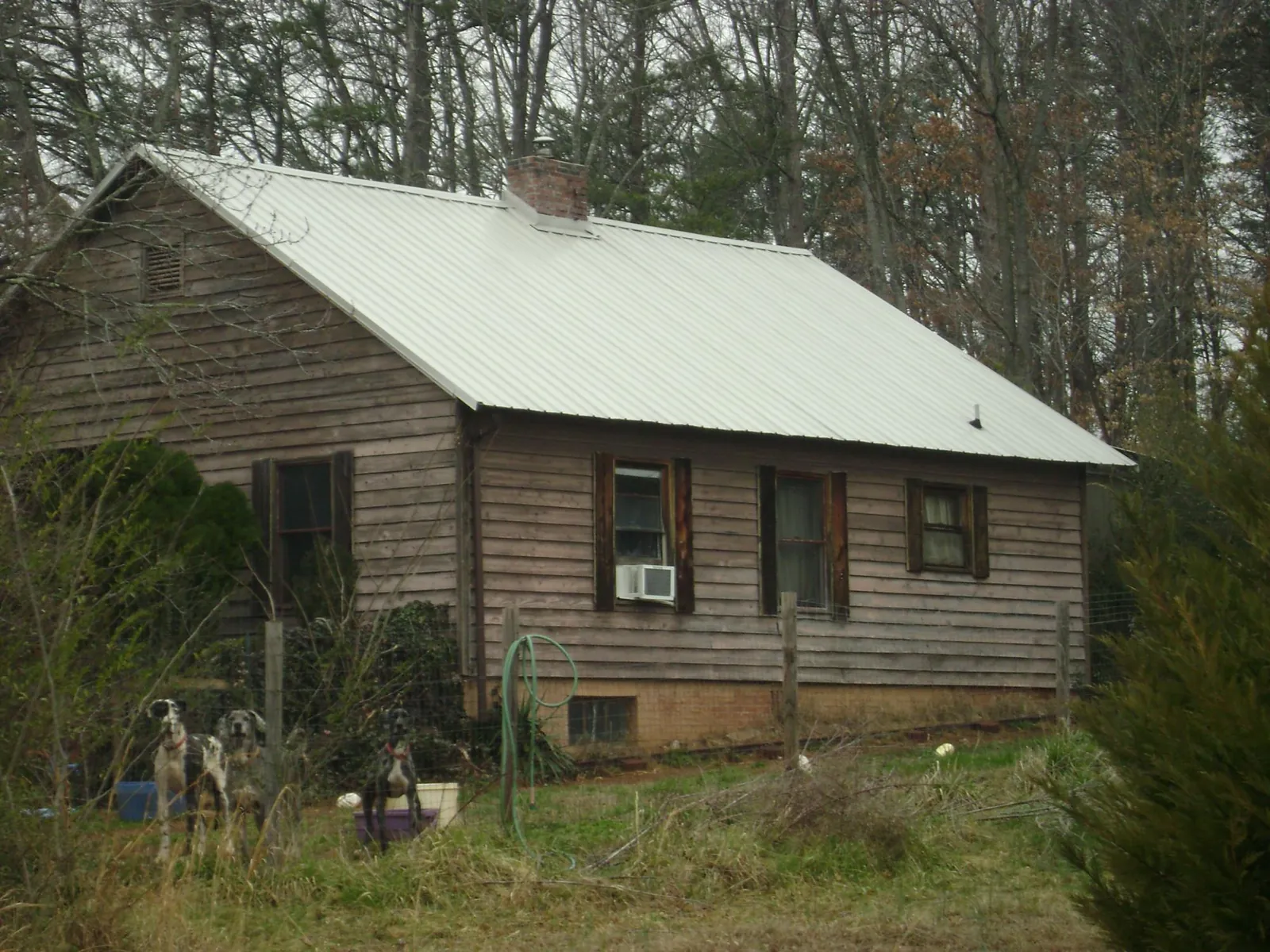 White metal roof on an old wood sided farmhouse, from a Metal Roof Installation job in Athol
